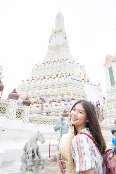 Pretty young asian backpack woman walking in the famous temple in Bangkok. Sightseeing in Thailand