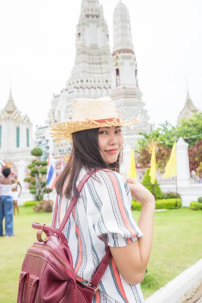 Asian girl tourist smiling while visiting Wat Arun or Temple of Dawn backpacker women, one day tour