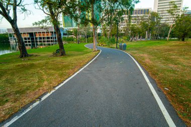 Şehir parkında asfalt yürüyüş ve koşu yolu akşam vakti doğa manzarası