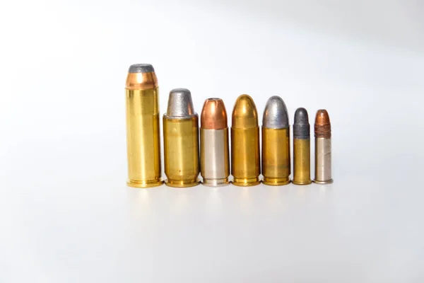 Group of pistol bullet .44 magnum 9mm and .45 on white background criminal concept