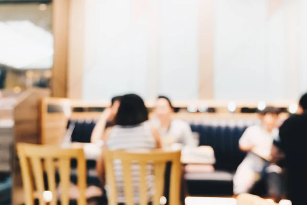 Blurred people sitting in restaurant order food and drink bokeh with toned