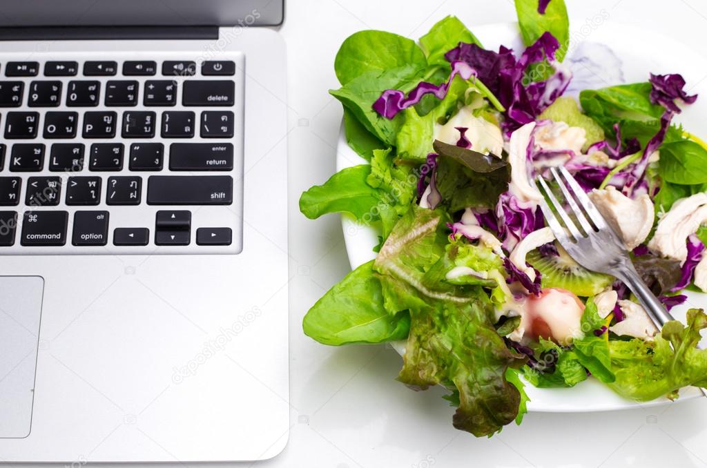 Many color salad with business laptop isolated on white 