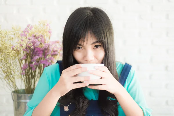 Beautiful young Asian woman with cup of coffee — Stock Photo, Image