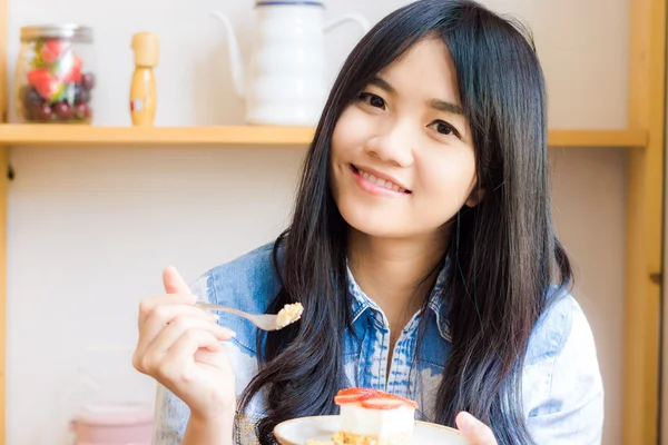 Portrait of smiling dark haired woman wearing jean shirt lap the — Stock Photo, Image