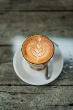 Latte üzerinde eski ahşap masa kahve fincan