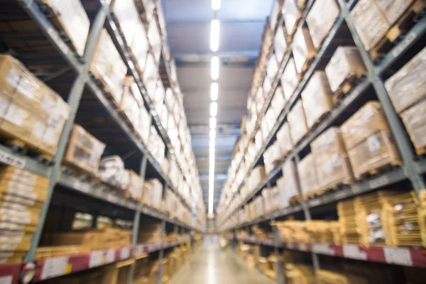 Abstract blurred boxes on rows of shelves — Stock Photo, Image