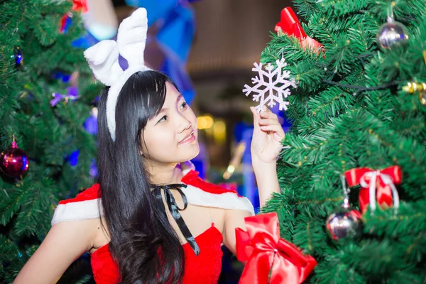 Азіатські жінки, що носіння одягу Санта-Клауса з дерева — стокове фото