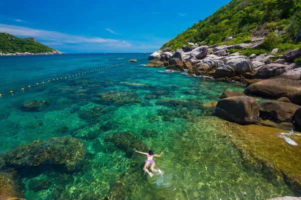Woman snorkeling in clear sea, Vacation time