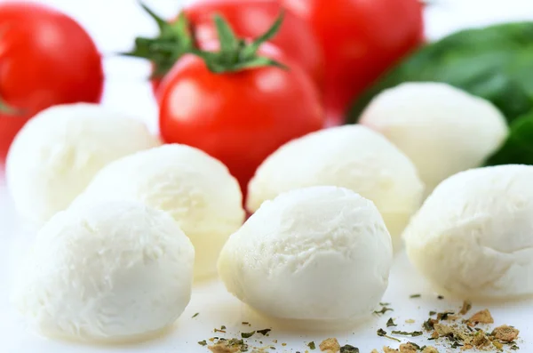 Mozzarella cheese balls, ripe cherry tomatoes, greens and spices — Stock Photo, Image