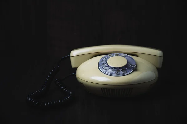 Przodu staromodny telefon na ciemnym tle drewnianych. głowicami p. — Zdjęcie stockowe
