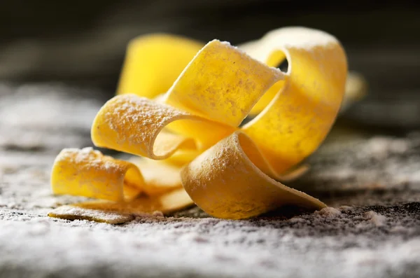 Flour and pasta on a dark background close-up horizontal — Stock Photo, Image