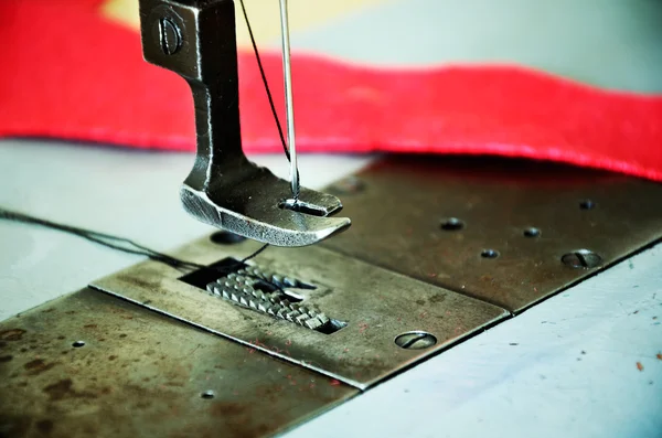 Part of sewing machine and red fabric close up. horizontal — Stock Photo, Image