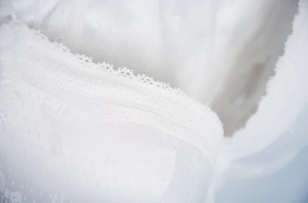 White lace lingerie hanging on the hanger close up, horizontal. — Stock Photo, Image