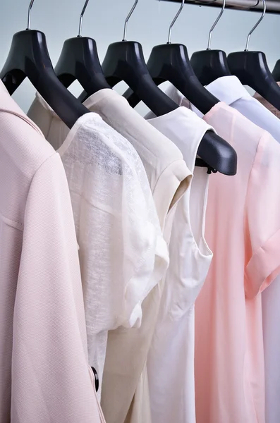 Womens clothing pastel colors hanging on the hanger vertical — Stock Photo, Image