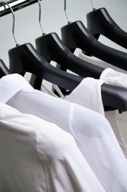 white womens clothing hanging vertical