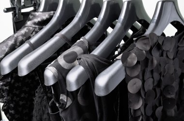 black womens clothing hanging on the black plastic hanger horizo clipart