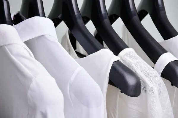 White womens clothing hanging close up horizontal — ストック写真