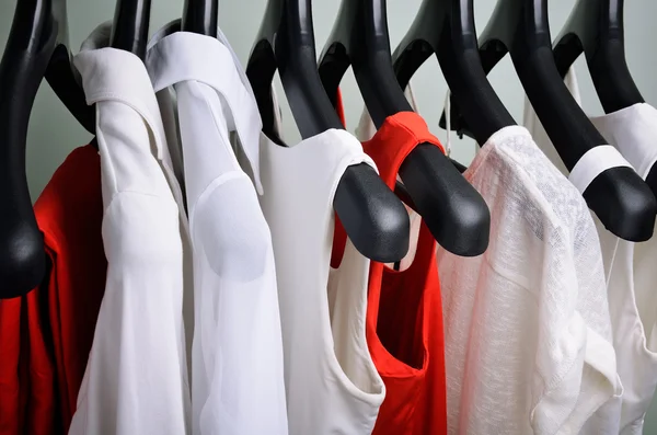 White and coral womens clothing hanging horizontal — ストック写真