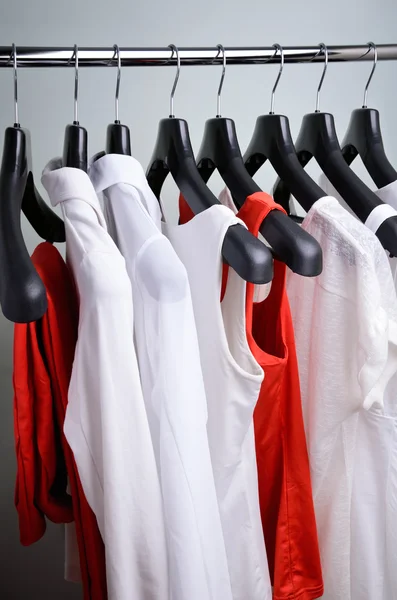 White and coral womens clothing hanging vertical — Stock Photo, Image