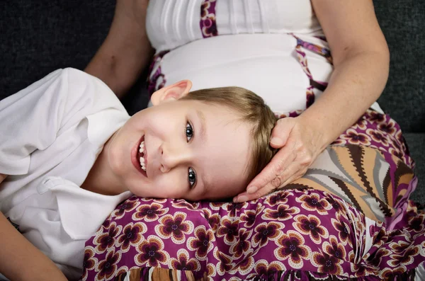 Laughing little boy looking at camera and his loving grandmother — Stock Photo, Image