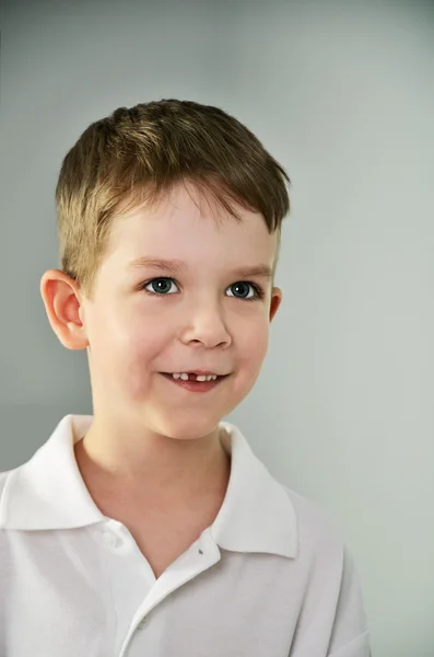 Little boy looking slyly. vertical portrait — Stock Photo, Image