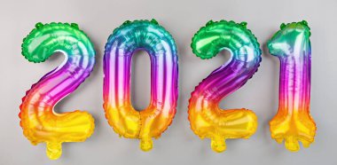 2021 yılınız kutlu olsun. Metalik balonlar beyaz üzerine gökkuşağı renkleri. Düz yatış, üst görünüm, model, genel giderler. Kış bayramı kutlaması