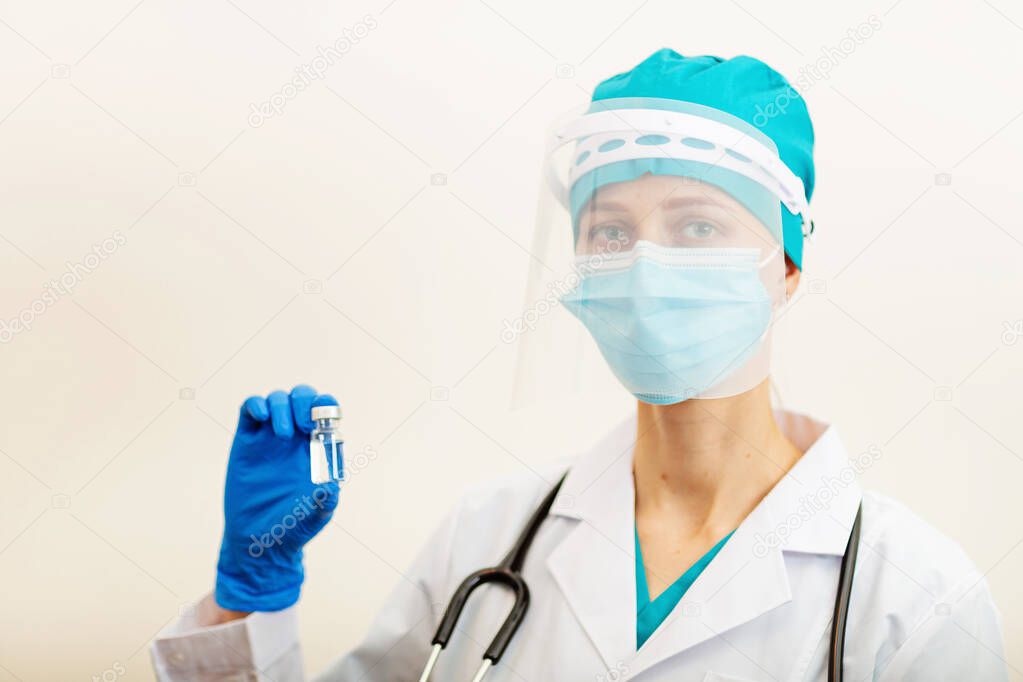 Doctor or nurse holding hands flu vaccine on beige background, measles injection syringe for baby, man, woman vaccination, medicine and drug concept. Vaccination against Coronavirus covid-19 pandemic . High quality photo