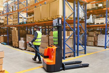 Depo çalışanı forklift kullanarak modern otomatik depoda kutu kullanıyor. Kutular ambarın raflarında. Depo, makine konsepti. Stokta lojistik.