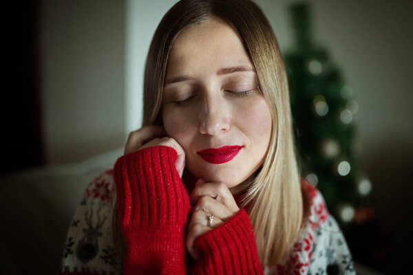 Белая женщина дома во время рождественских каникул. Портрет молодой потрясающей модели с ярко-красными губами. Современная мода и молодежная концепция. Оставайтесь дома из-за карантина коронавируса ковид-19