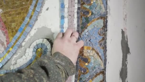 Craftsperson controls quality of grey piece of mosaic — Stock Video