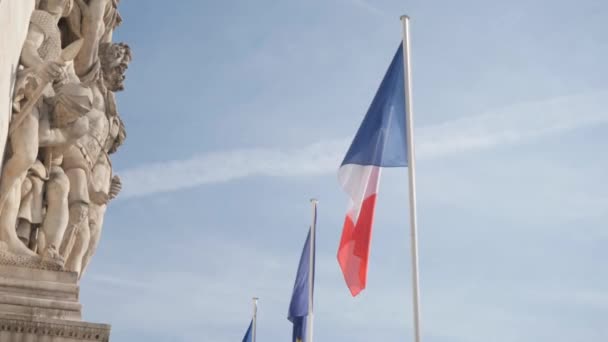 Флаги Франции размахивали мягким ветром возле Триумфальной арки — стоковое видео