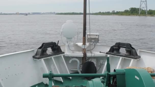 Large ship bow with green and white equipment sails on river — Stock Video