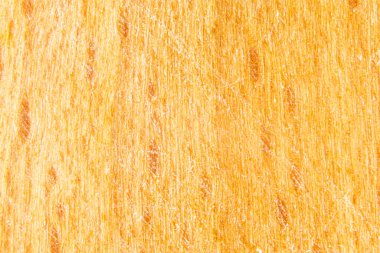 Tahta kesme tahtası dokusu. Büyük zımpara kağıdı çizikleri olan kumlu ahşap. Sarı-turuncu tahta.