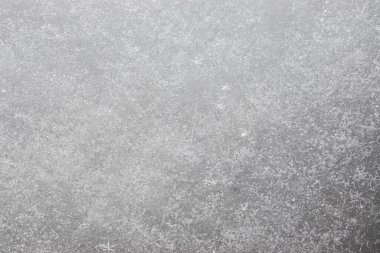 Yeni yağmış taze karın yakın plan çekimi. Ayrı ayrı parlayan kar taneleri. Katı bir kar tabakasının dokusu.