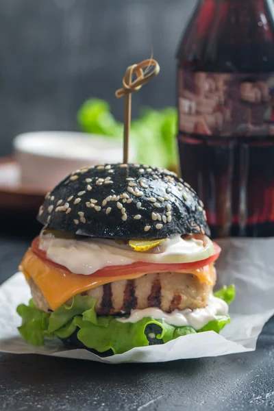 black burger with grilled chicken patty