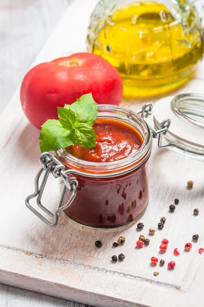 Glass jar with homemade classic spicy tomato sauce — Stock Photo, Image