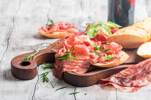 Concept of italian food with red wine, melon and prosciutto — Stock Photo, Image