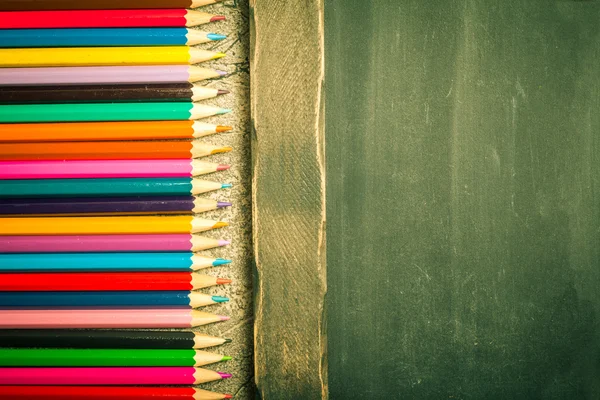 Multicolored pensils and chalk board — Stock Photo, Image