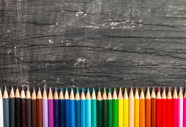 Multicolored pensils and chalk board — Stock Photo, Image