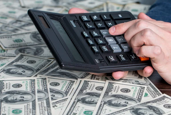 Mans hands with money and calculator — Stock Photo, Image