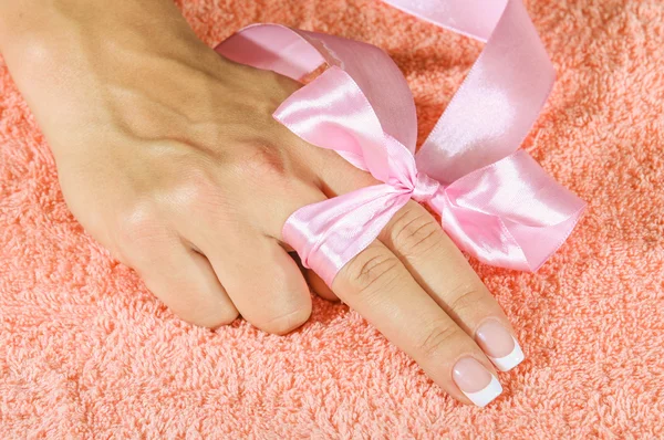 French manicure with pink and red hearts on the nails. — Stock Photo, Image