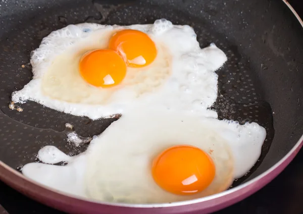 Close-up photo of two scrambled eggs in  pan — Stock Photo, Image