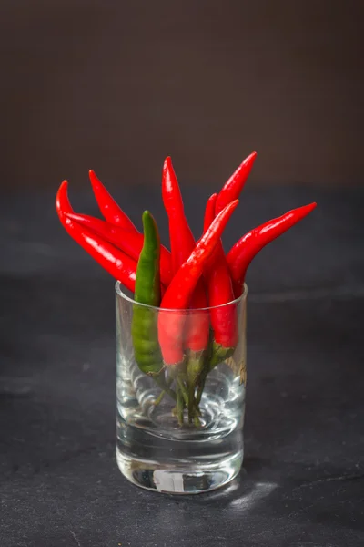 Red chile pepper  in glass — Stock Photo, Image