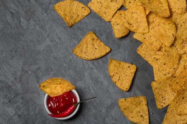 Nachos with hot salsa sauce and a red hot chili pepper — Stock Photo, Image