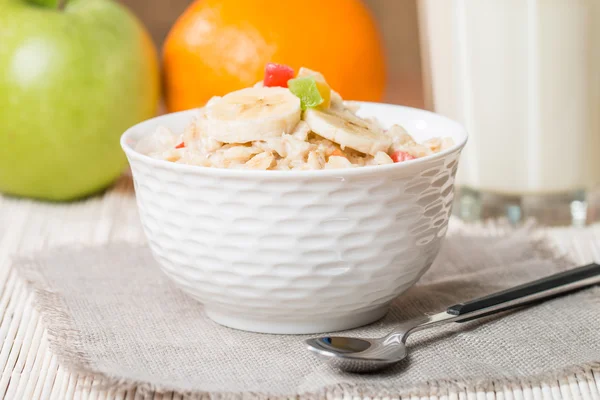 Oatmeal with candied fruils and milk — Stock Photo, Image