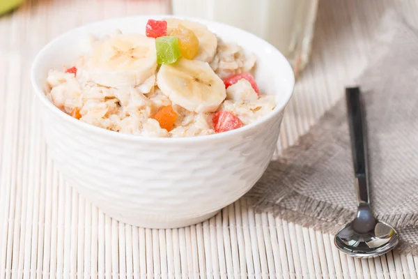 Oatmeal with candied fruils and milk — Stock Photo, Image