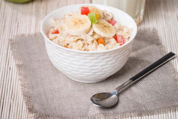 Oatmeal with candied fruils and milk — Stock Photo, Image