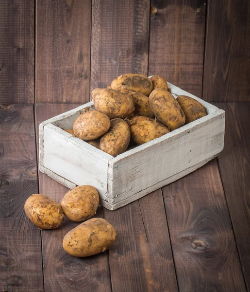Fresh young potatoes in white wooden box — Stock Photo, Image