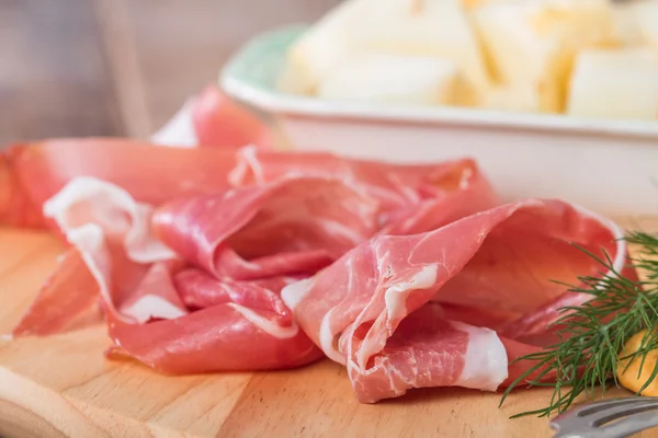 Italian food with melon and prosciutto — Stock Photo, Image