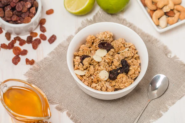 Granola, honey, nuts and raisins — Stock Photo, Image